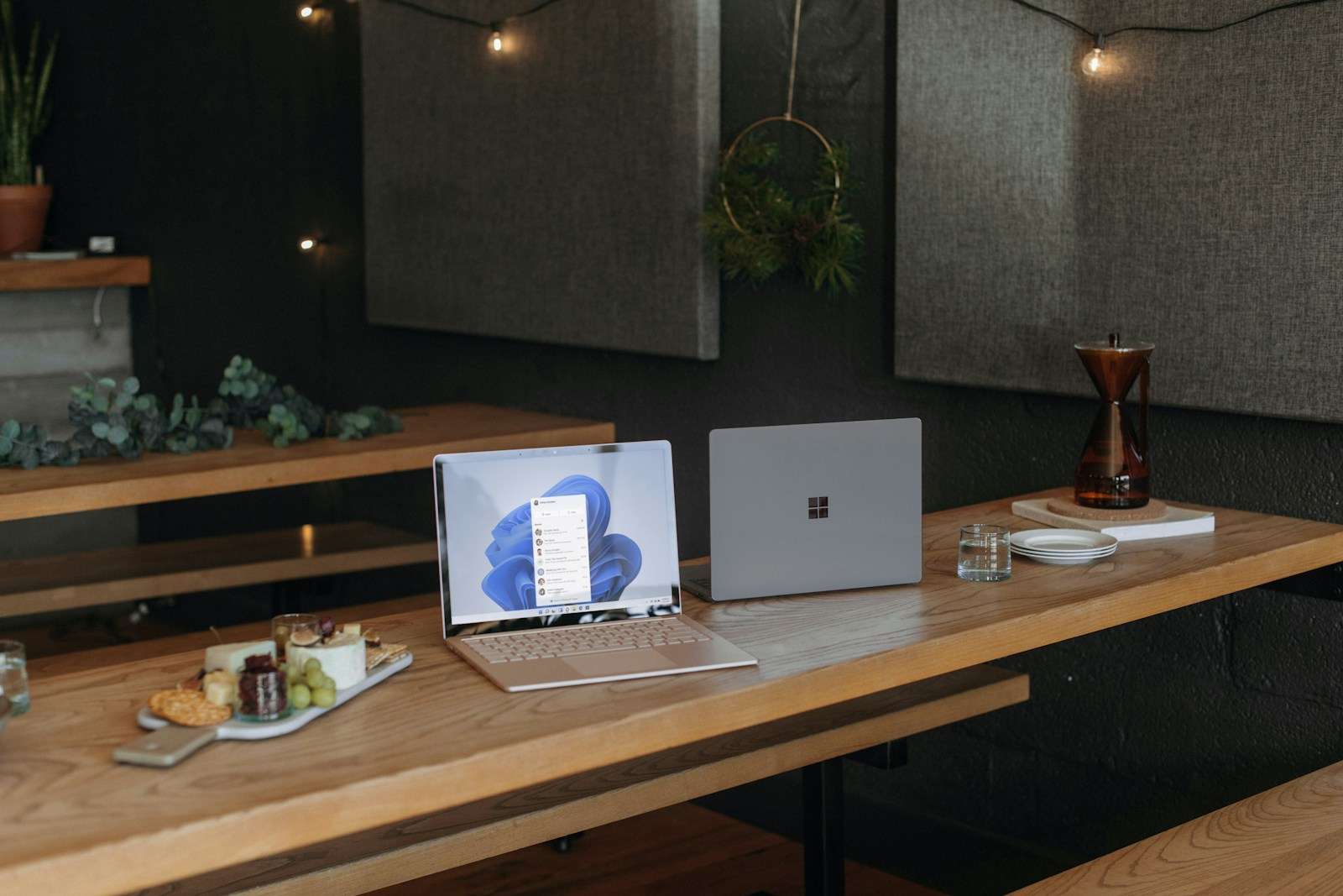 Two Microsoft laptops on a table in an office during the holidays